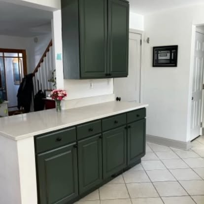 Deep green kitchen cabinets professionally refinished by Jersey Pro Painters