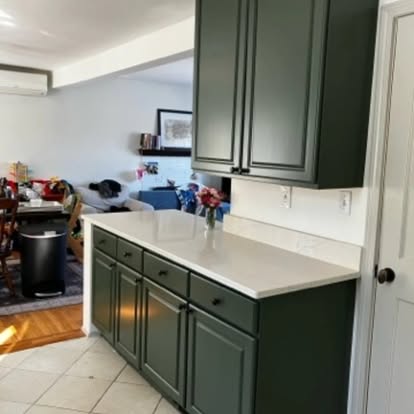 Finished green kitchen cabinets from the opposite angle